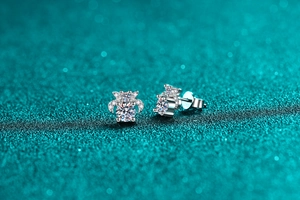 Macro shot of S925 sterling silver moissanite stud earrings showing the hallmark stamp