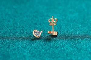 Macro detail of heart-shaped S925 silver moissanite stud earrings in rose gold finish