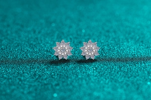 Macro shot of S925 sterling silver snowflake stud earrings with moissanite stones