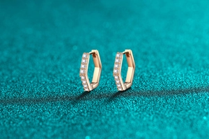 Macro detail of hexagonal rose gold earrings featuring small white zircon inlay craftsmanship