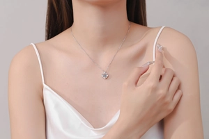 Detailed view of square blue gemstone pendant with S925 sterling silver chain on neck