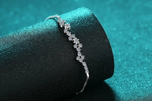 Close-up of S925 silver star bracelet with shimmering moissanite on a black display