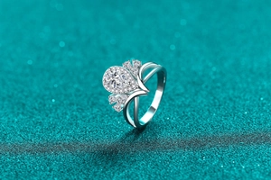 Macro view of pear-cut moissanite ring with halo setting and V-shaped hollowed band