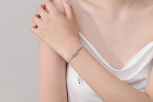 Detailed view of S925 sterling silver bracelet with blue stones on a model's wrist