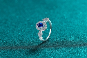Close-up of S925 silver ring featuring an oval blue moissanite and sparkling white zircons