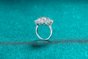 Detailed macro view of pear-shaped moissanite ring with brilliant floral diamond cluster halo