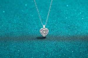 Macro shot of S925 sterling silver heart-cut moissanite pendant necklace with fine O-chain