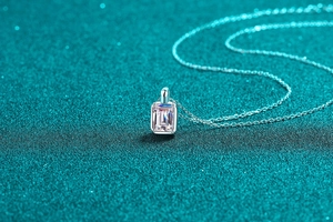 Macro detail of radiant cut pink moissanite pendant on a sterling silver O-chain