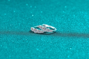 Macro shot of S925 sterling silver huggie earrings with sparkling moissanite stones