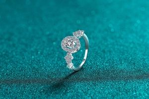 Macro side view of S925 sterling silver ring with oval blue gemstone and halo diamonds