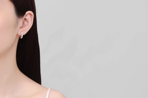 Minimalist S925 sterling silver hoop earring with moissanite on a female model's ear