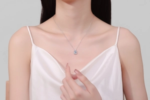 Close-up of S925 sterling silver necklace with square cut moissanite pendant on model