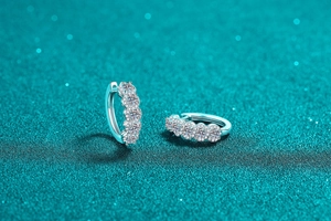 Macro shot of S925 sterling silver huggie earrings with five brilliant moissanite stones
