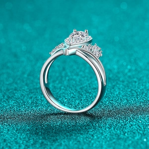 Elegant pear-cut moissanite silver ring with split shank on a teal textured background