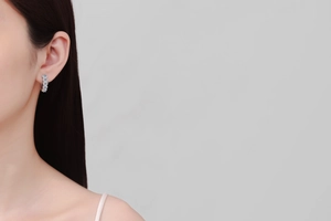 Close-up of a model wearing elegant S925 sterling silver moissanite paved hoop earrings