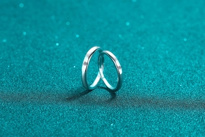 Close-up of minimalist S925 sterling silver couple rings with sparkling moissanite accents