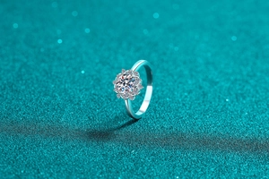Macro shot of S925 silver sunflower ring with moissanite halo setting on blue background
