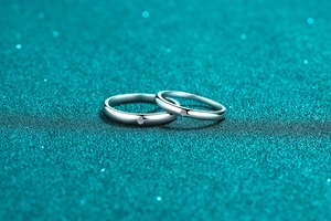 Macro shot of minimalist S925 sterling silver couple rings with bright small diamonds