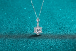 Macro shot of silver snowflake pendant necklace with sparkling moissanite stone