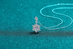 Close-up of sparkling moissanite snowflake pendant on a silver necklace chain