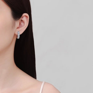 Elegant S925 sterling silver hoop earrings with moissanite diamonds worn by a model