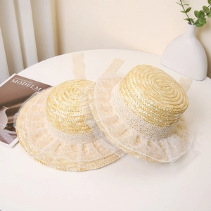 Handmade straw boater hat with delicate white lace ribbons and polka dot mesh decor