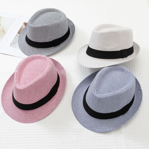 Detailed view of woven textures and striped patterns on assorted summer fedora hats