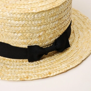 Classic flat top straw boater hat with black ribbon and bow for summer beach vacation