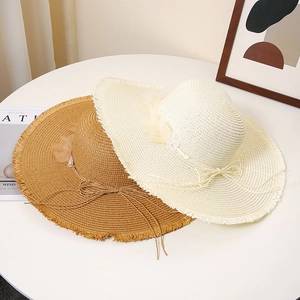 Women's wide brim straw sun hat with delicate lace flowers and frayed edge detail
