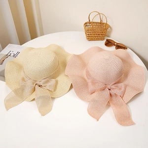 Elegant wide brim straw hats in beige and pink with delicate mesh bow for summer sun protection