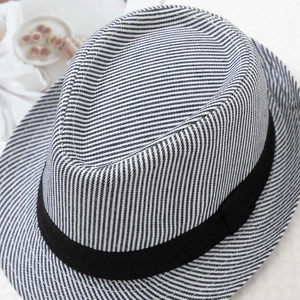 Detail of navy blue striped fedora hat with black band and woven texture on fabric