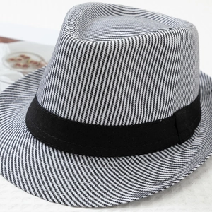 Detailed close-up of striped jazz fedora with black ribbon band and textured fabric