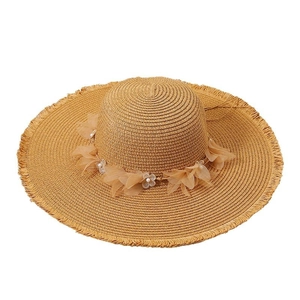 Brown wide brim straw hat with lace flower, pearls and fringe detail for summer beach sun protection