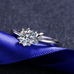 Classic round moissanite ring with six-prong setting and delicate leaf design on band