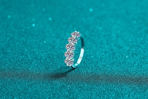 Macro shot of 925 sterling silver ring with five sparkling round-cut moissanite stones