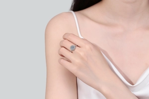 Close-up of S925 silver moissanite halo ring with floral setting on a model finger