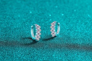 Detail of S925 sterling silver hoop earrings with five channel-set rectangular pink stones