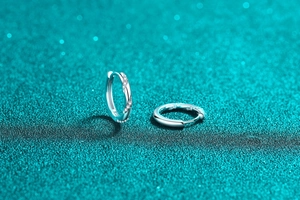 Macro shot of S925 sterling silver hoop earrings with twisted design and zircons