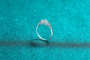 Macro shot of square-cut moissanite ring in S925 silver with side accent diamonds