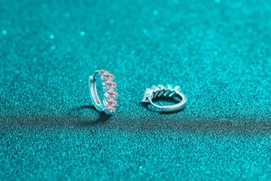 Macro detail of S925 sterling silver hoop earrings with emerald-cut moissanite stones