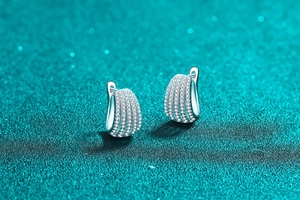 Macro detail of S925 sterling silver hoop earrings with four rows of sparkling moissanite