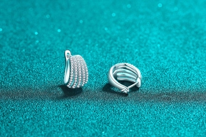 Detailed macro view of S925 sterling silver hoop earrings with multi-row pavé moissanite