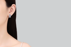 Close-up of S925 sterling silver moissanite hoop earrings worn by a model