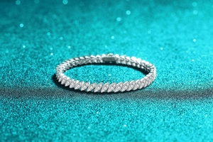 Detail shot of marquise-shaped links on a sparkling silver moissanite tennis bracelet