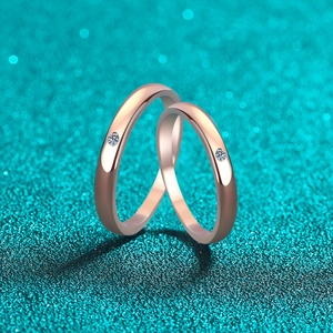 Polished rose gold S925 silver couple rings with moissanite stones on glitter background