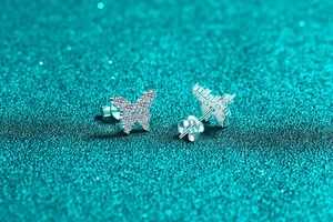Close-up of S925 sterling silver butterfly earrings with sparkling moissanite stones