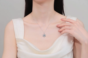 Elegant S925 silver snowflake necklace with moissanite pendant worn by a female model