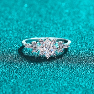Elegant S925 sterling silver ring with princess cut moissanite on blue glitter background