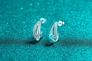Detail of S925 silver moissanite earrings with double-layer C-shape on glitter background