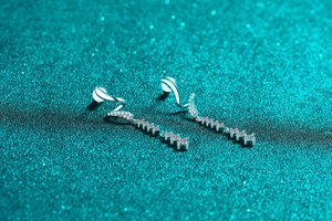 Macro shot of S925 sterling silver drop earrings with shimmering white moissanite stones